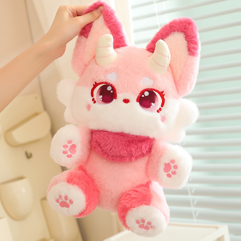 Close up of sparkling anime eyes and soft ears on fairy fox plush